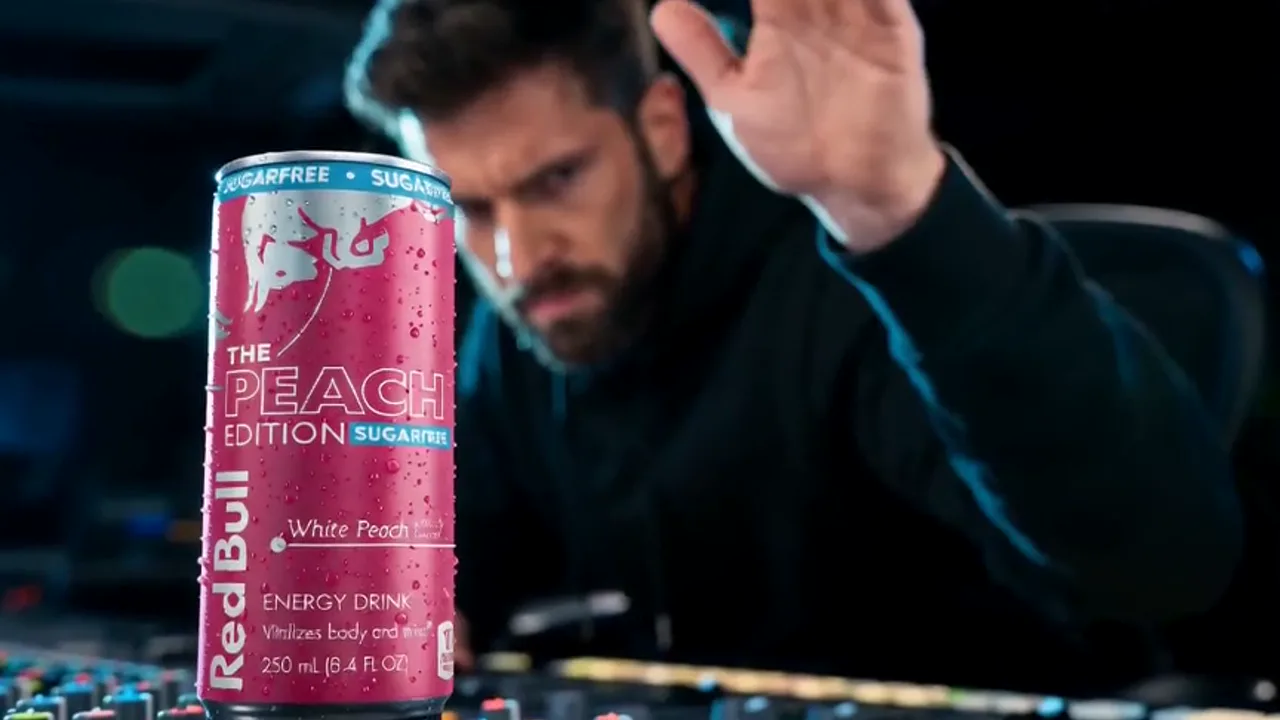 Red Bull Peach Edition spec film — a producer in a black hoodie at a mixing console with a can of Peach Edition