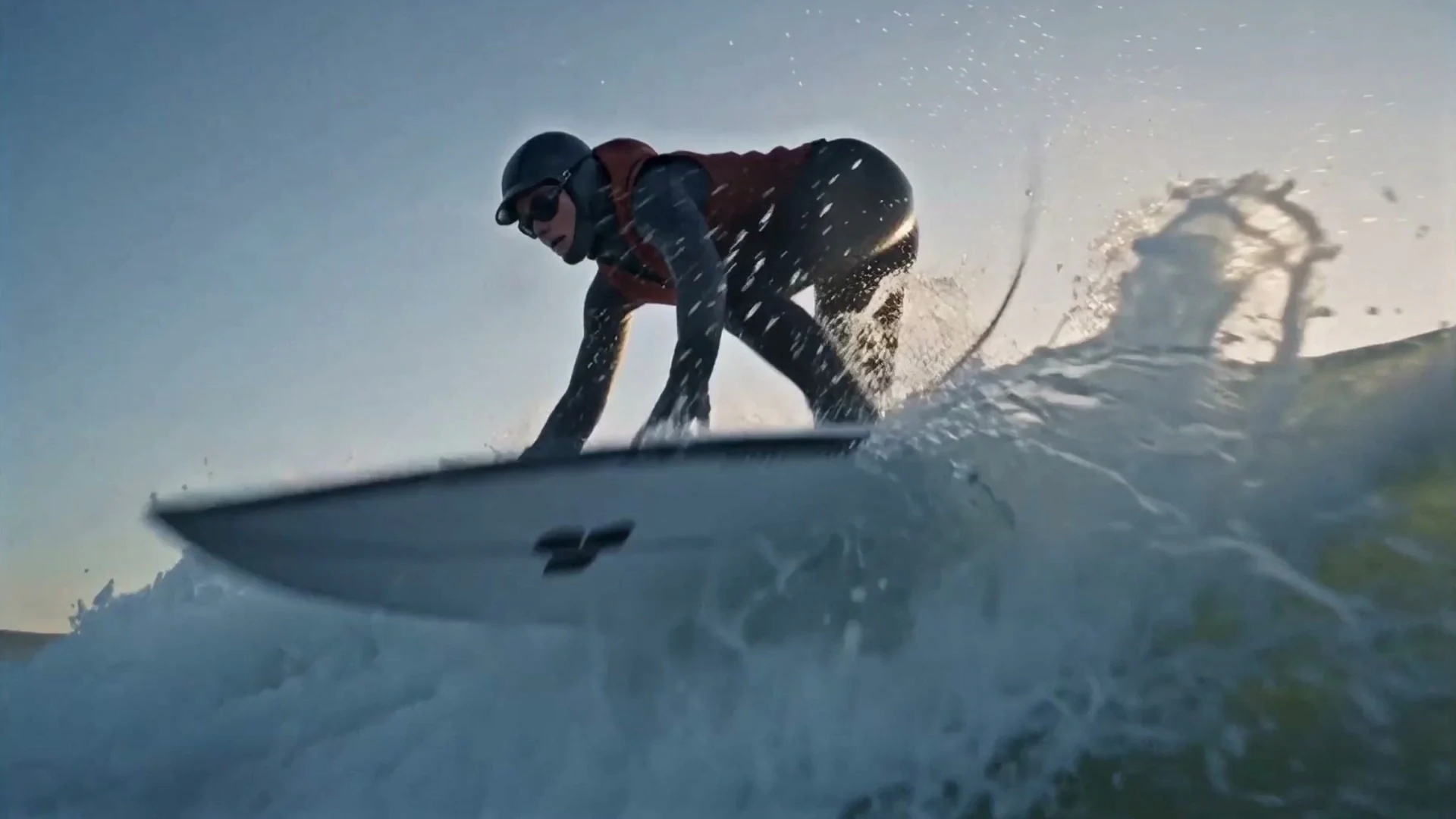 A surfer carving a wave at sunrise, a frame from a cinematic film made in Fotyra Studio